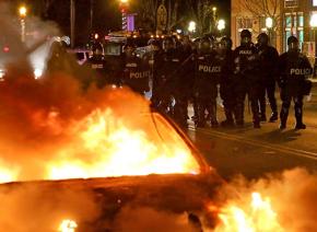 Police clad in riot gear after the Ferguson grand jury is announced